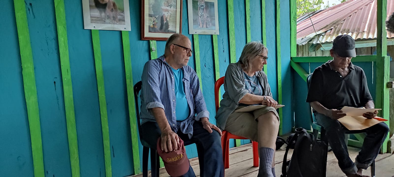 Scott, Jean and Pablo looking at pictures